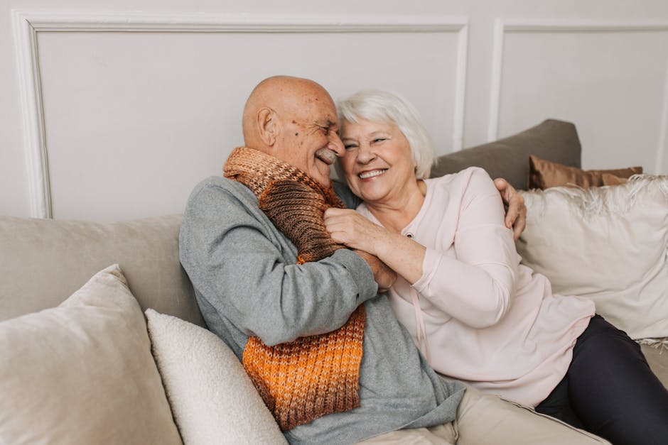 pexels-photo-5790710-5790710 Happy elderly couple embraced in a cozy home setting, sharing joyful smiles.